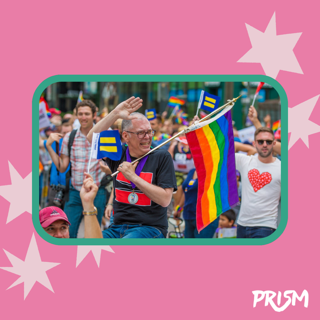 Jim Obergefell waves to the crowd at San Francisco Pride 2015 while holding a rainbow pride flag. Image retrieved from Flickr under Creative Commons licensing. 