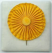 Painting of a sunflower made out of ribbon.